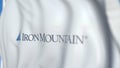 Waving flag with Iron Mountain logo, close-up. Editorial 3D rendering