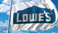 Waving flag with Lowe`s logo against sky and clouds. Editorial 3D rendering