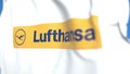 Flying flag with Lufthansa logo, close-up. Editorial 3D rendering