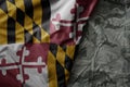 waving flag of maryland state on the old khaki texture background. military concept Royalty Free Stock Photo