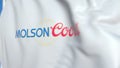 Waving flag with Molson Coors Brewing Company logo, close-up. Editorial 3D rendering