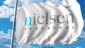 Waving flag with Nielsen Holdings logo. Editoial 3D rendering