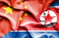 Waving flag of North Korea and China