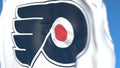 Waving flag with Philadelphia Flyers NHL hockey team logo, close-up. Editorial 3D rendering