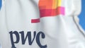 Waving flag with PricewaterhouseCoopers PwC logo, close-up. Editorial 3D rendering