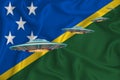 Waving flag of Solomon Islands. UFO group on the background of the flag. UFO news concept in the country. 3D rendering