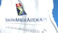 Waving flag with South African Airways logo, close-up. Editorial 3D rendering