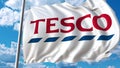 Waving flag with Tesco logo against sky and clouds. Editorial 3D rendering