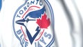 Waving flag with Toronto Blue Jays team logo, close-up. Editorial 3D rendering