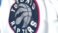 Flying flag with Toronto Raptors team logo, close-up. Editorial 3D rendering