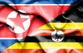 Waving flag of Uganda and North Korea