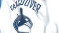 Waving flag with Vancouver Canucks NHL hockey team logo, close-up. Editorial 3D rendering