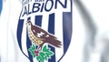 Flying flag with West Bromwich Albion FC football club logo, close-up. Editorial 3D rendering