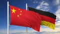 Waving flags of China and Germany on flagpole