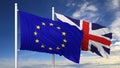Waving flags of EU and UK on flagpole