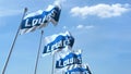 Waving flags with Lowe`s logo against sky, editorial 3D rendering