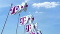Waving flags with T Telekom logo against sky, editorial 3D rendering