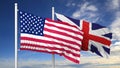 Waving flags of USA and UK on flagpole Royalty Free Stock Photo