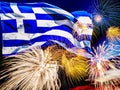 Waving greek flag against sunset sky with colorful exploding fireworks. Celebration day concept. Greece flag with salute Royalty Free Stock Photo