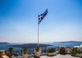 Waving Greek flag on viewing platform in Santorini Royalty Free Stock Photo