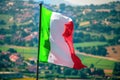 Waving italian flag wave countryside background