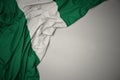 Waving national flag of nigeria on a gray background Royalty Free Stock Photo