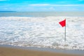 Waving red flag at seashore Royalty Free Stock Photo