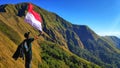 waving the red and white flag on the hill