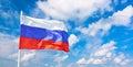 Waving russian flag against blue cloudy sky background Royalty Free Stock Photo