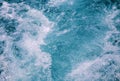 Waving sea surface top view photo. Tropical islands boat travel. Cruise ship trail. Royalty Free Stock Photo