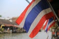 Waving Thailand flag at outdoor with water market