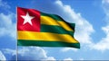 Waving Togo flag over sky with clouds, seamless loop. Motion. Rippling colorful flag with the five pointed star on