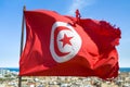 Waving tunisian flag on the background of the medieval medina in Sousse, Tunisia. Royalty Free Stock Photo