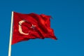 Waving Turkish Flag at sunset isolated on blue sky background Royalty Free Stock Photo