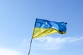 Waving Ukrainian yellow-blue flag against a blue sky Royalty Free Stock Photo