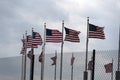 Waving usa flags behind fence grid Royalty Free Stock Photo