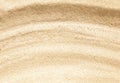 Wavy beige sand texture background close up