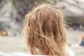 Wavy blond hair of a child on the beach