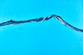 Wavy clear water on blue background with drops. Royalty Free Stock Photo