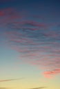 Wavy colored lines of clouds in sky at sunset