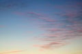 Wavy colored lines of clouds in sky at sunset