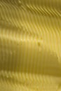 Wavy contours in spreadable margarine. Vertical food texture image