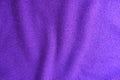 Wavy folds on violet knitted fabric