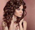 Wavy hair. Beautiful girl with makeup. Curly hairstyle. Brunette
