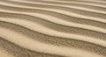 Wavy patterns of sand are shaped by the wind, forming parallel ridges. The texture Royalty Free Stock Photo