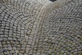 Wavy paving of cubes in the form of a woman bust. creates a gutter saddle between two hills. the bumpy steep paving copies the ter Royalty Free Stock Photo