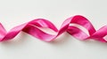Wavy Pink Ribbon Gracefully Cascading on a Subtle Textured White Surface for Decoration and Craft Projects Royalty Free Stock Photo