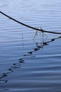 Wavy reflection of boat mooring rope in water Royalty Free Stock Photo