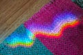 A wavy reflection of the iridescent stratification of sunlight on grandmother's old carpet. Fairy tale atmosphere Royalty Free Stock Photo