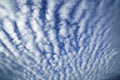 Wavy and rippled white clouds in blue sky, abstract nature patterns Royalty Free Stock Photo